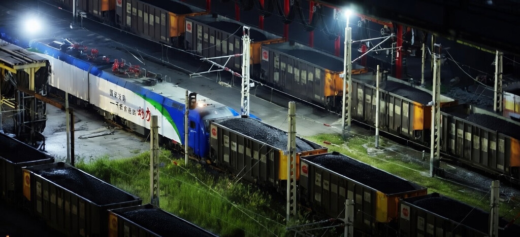 Freight train carrying coal at a rail yard in China, illustrating Russian coal exports to China and cross-border coal transport logistics.