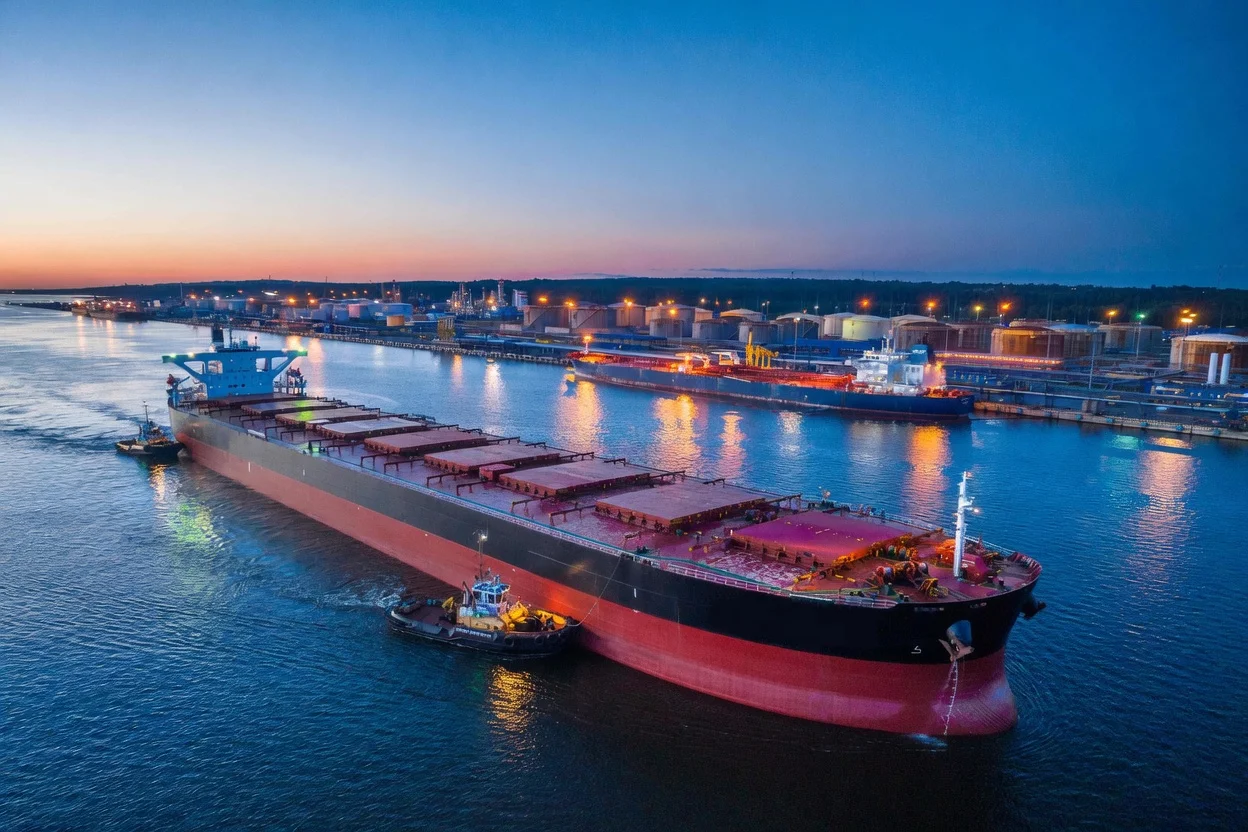 Bulk carrier vessel being loaded with coal at a Russian Baltic port terminal during sunset