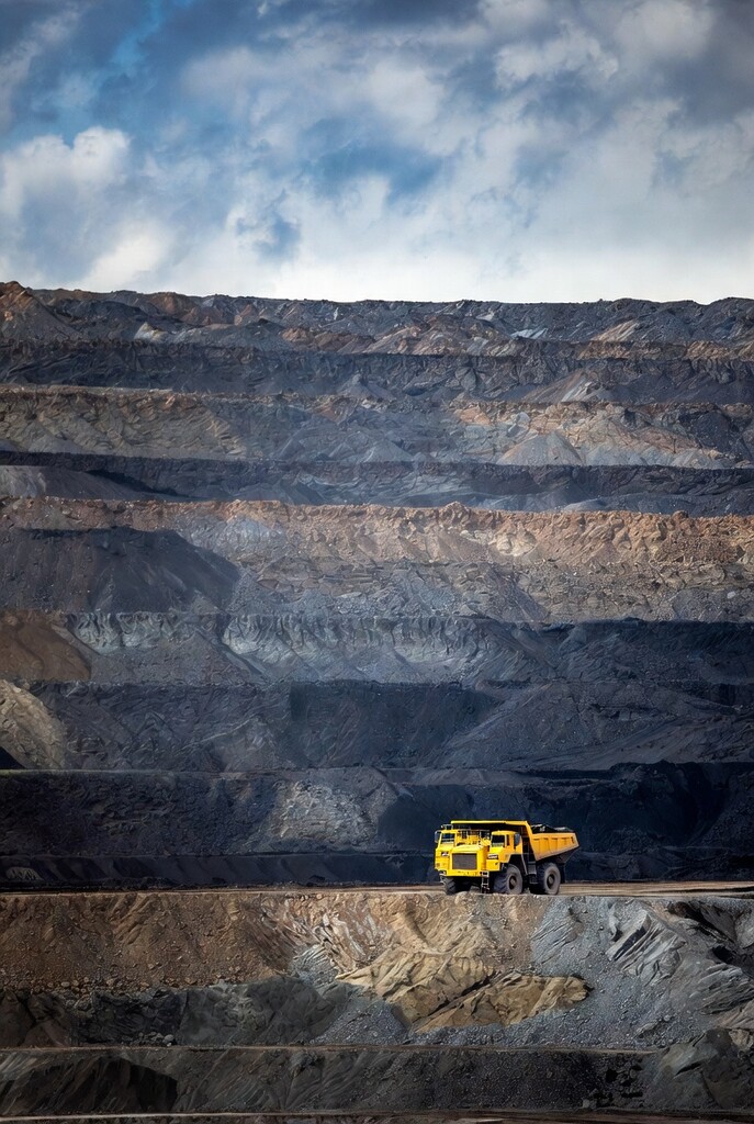 Yellow haul truck in a large open-pit coal mine in Russia