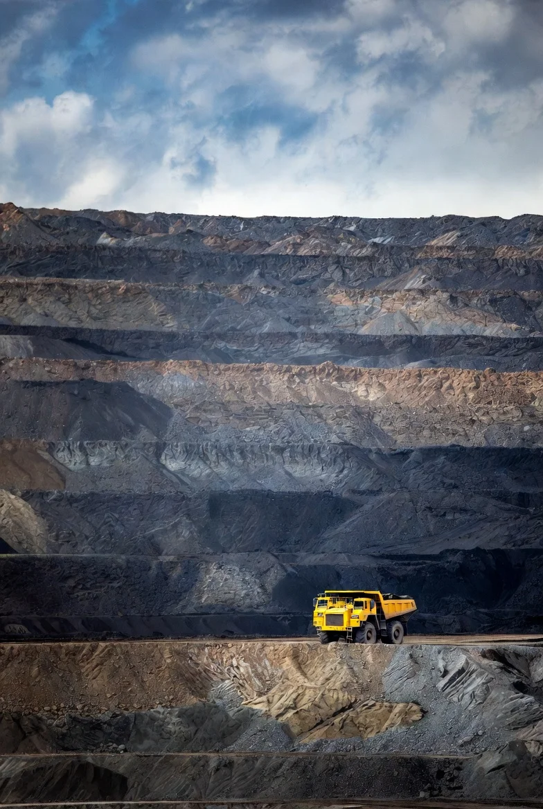 Yellow haul truck in a large open-pit coal mine in Russia