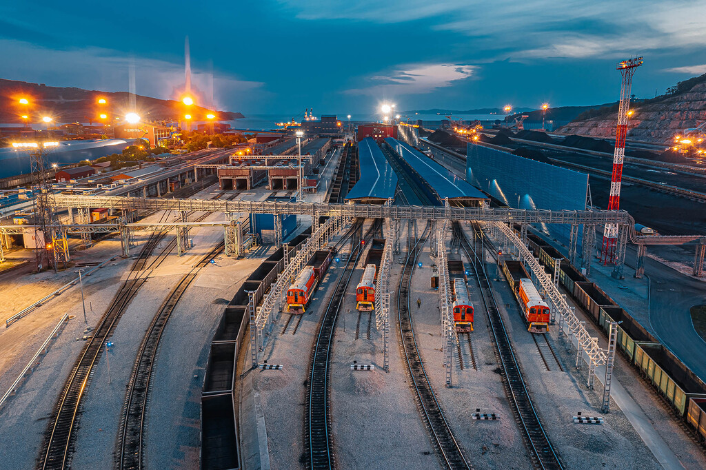 Coal export terminal with rail infrastructure and stockpiles at dusk