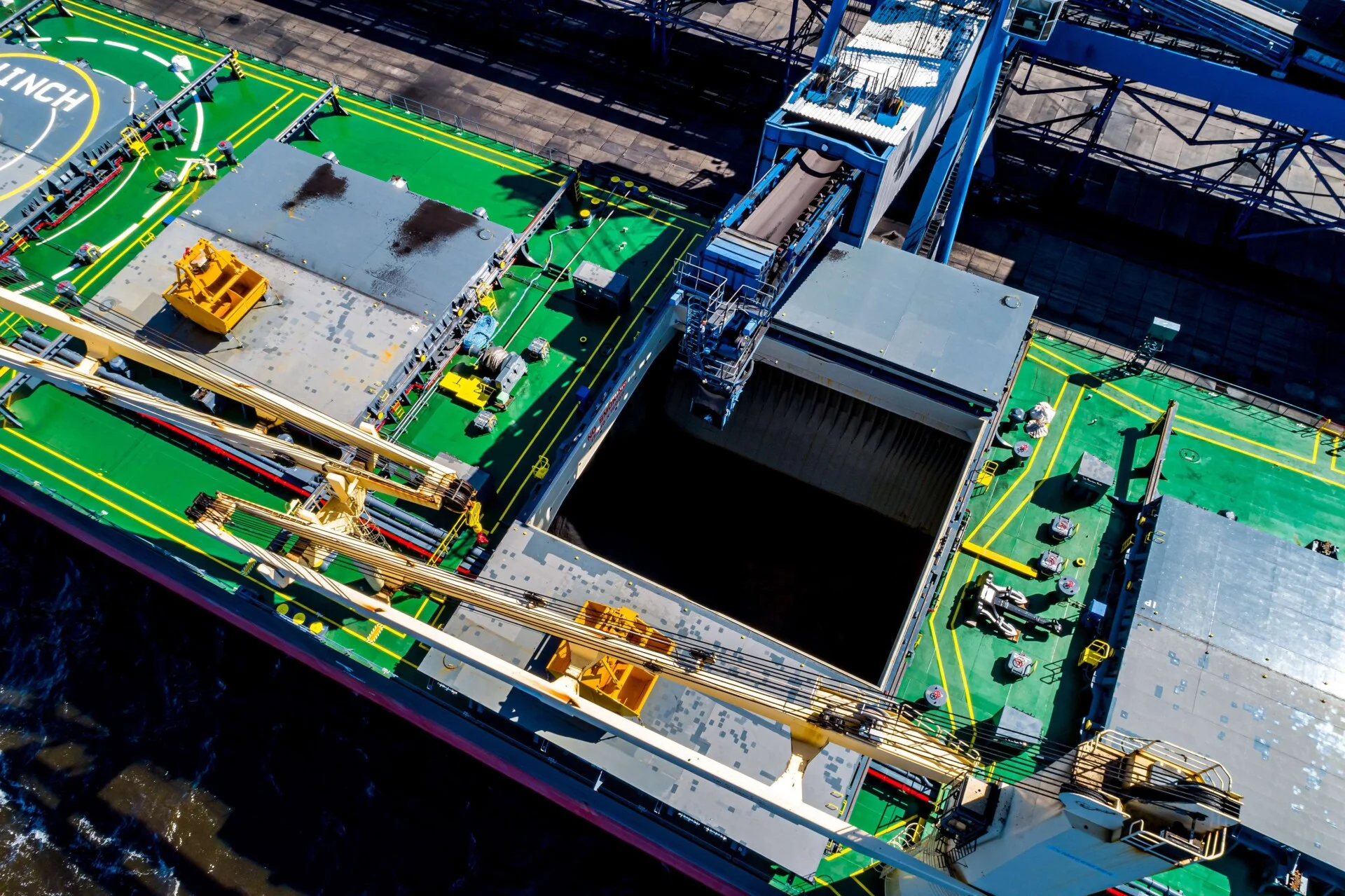 Kazakh coal handling 7 months 26 | The Coal Hub Aerial view of coal being loaded into a bulk carrier at a port terminal.