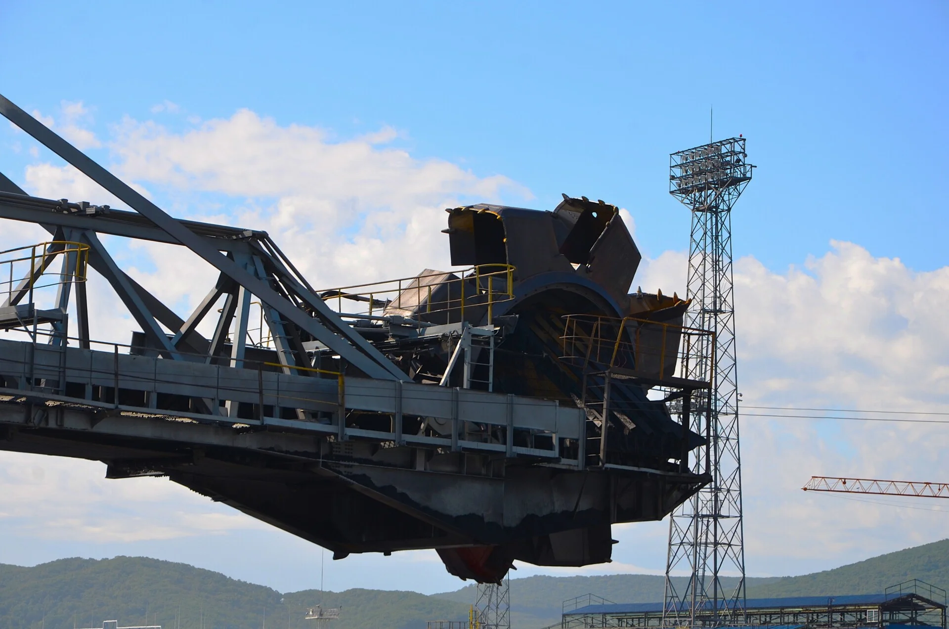 Close-up of coal handling equipment and conveyor structure at an export terminal.